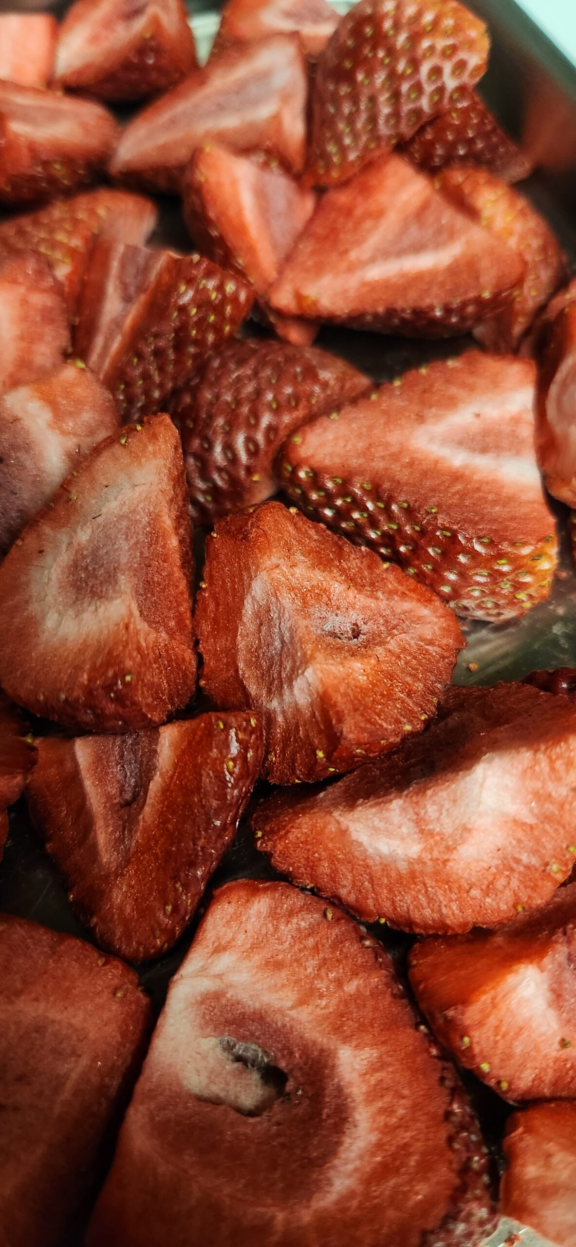 Close-up of sliced strawberries with a focus on texture and color.