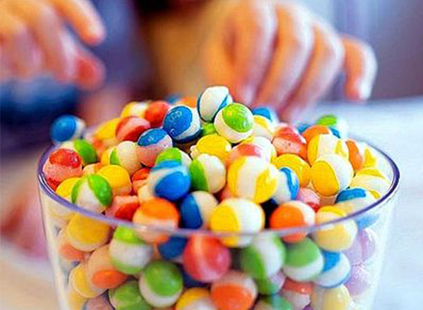 The image shows freeze-dried Skittles candy, a popular snack with a unique texture.