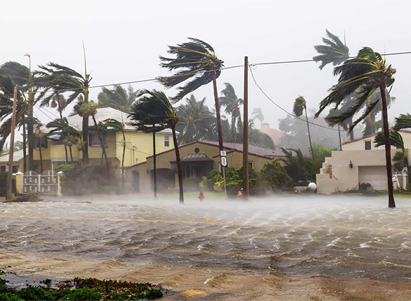 The image captures a powerful hurricane making landfall, characterized by extreme winds and significant coastal flooding. 