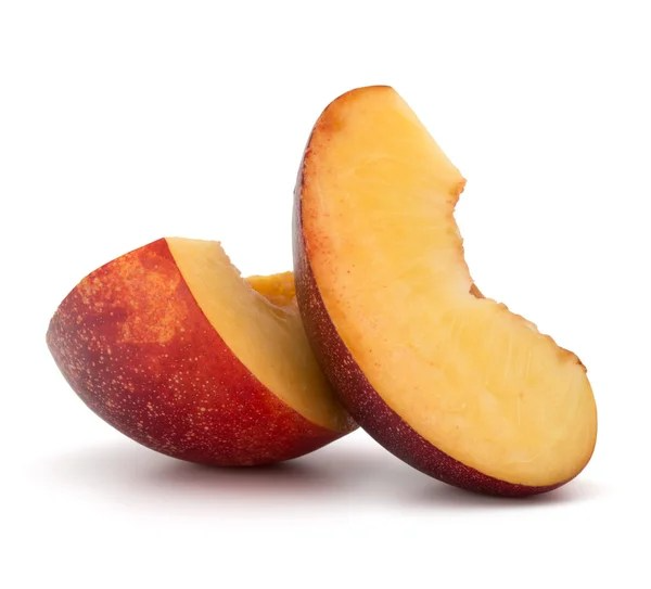 Two slices of Nectarines on a white background