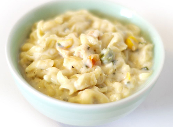 The image shows a serving of creamy pasta. 